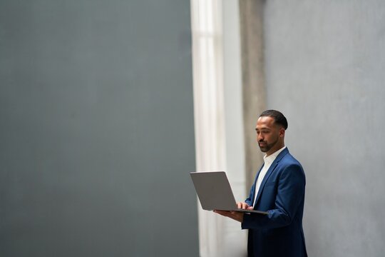 Business professional working on laptop in modern architecture