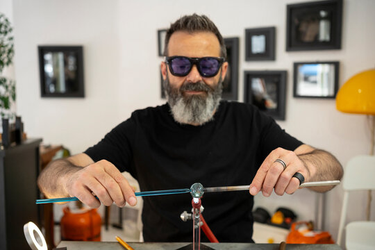 Artisan joining pieces of glass