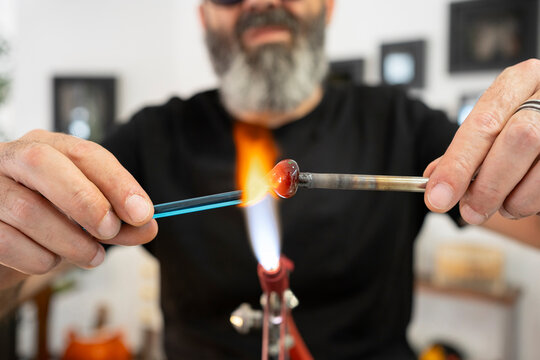 Artisan joining pieces of glass