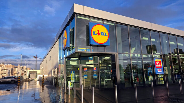 COLMENAR VIEJO (MADRID), SPAIN - JANUARY, 16, 2026. Modern supermarket Lidl exterior at sunset featuring glass facade and urban architecture