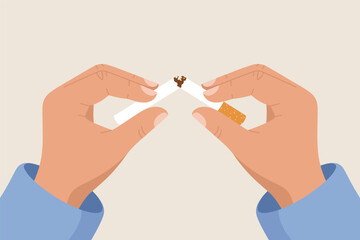 Person quitting smoking with broken cigarette in hands