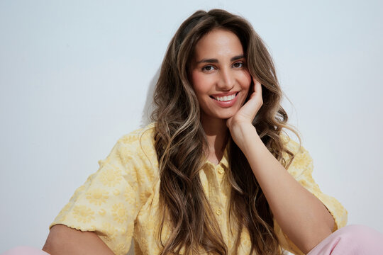 Smiling woman portrait over white wall