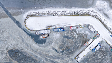 boats on ice in the port
