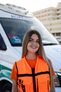 Paramedic near ambulance in urban setting