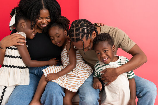 Family snuggling together in a studio setting