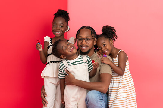 A dad poses with his children