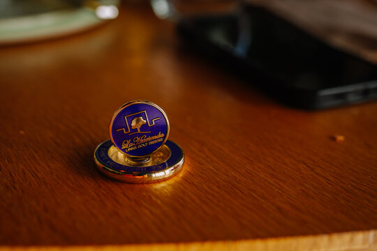 La Casona hotel token displayed on a wooden table with a smartphone and glass in the background