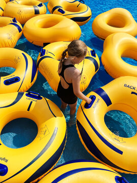 Young girl with yellow floaties in a pool
