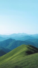 Lush hills of green intersect with a towering mountain peak set against a vibrant blue sky