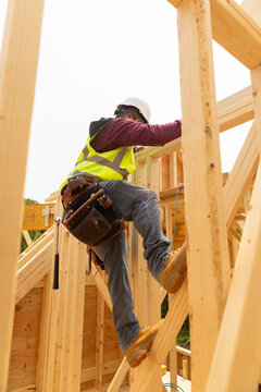 Hispanic Construction employee  climb