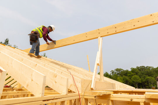 Construction Site measures piece of wood roof