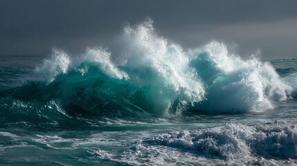 Big, frothy ocean waves crash and spray on the water under a gray and blue sky.