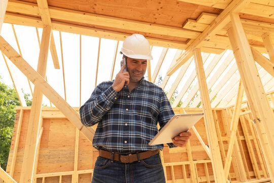 Worker Construction Site with cell phone 
