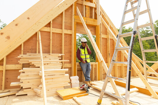 Construction worker taking break on cell phone 