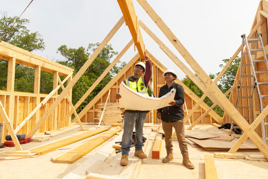 Construction wood manager meets with house plans 