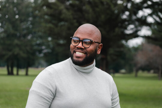 Confident Plus-Size Man in Turtleneck Posing Outdoors