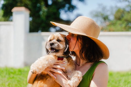 Woman embraces her dog in the backyard