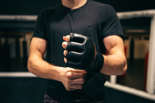 MMA fighter adjusting his gloves