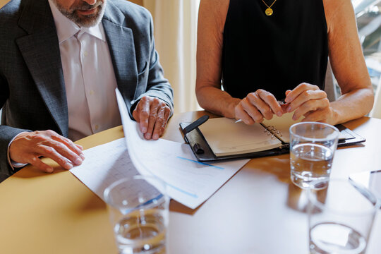 Financial advisors examining documents during meeting