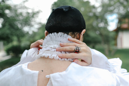 a woman holds a wig in her hands