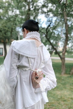 a woman holds a wig in her hands
