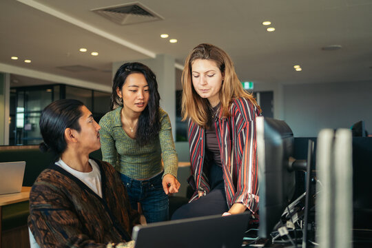 Coworkers Collaborating In A Modern Office