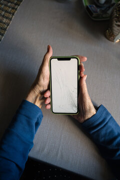 Broken screen phone senior hands