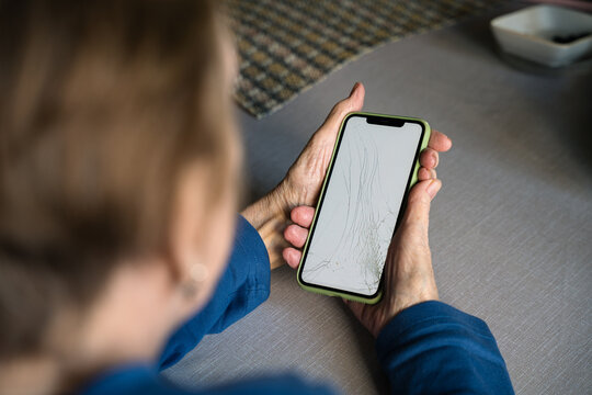 Broken screen phone senior hands