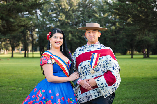 Cueca Dance Champions Holding Hands in Traditional Attire