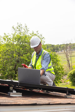 Home Solar Panel engineer worker laptop roof 