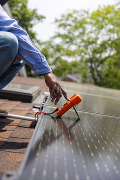 Close Up Solar Panel Multimeter output test hand