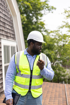 Black Construction Worker walkie talkie roof 
