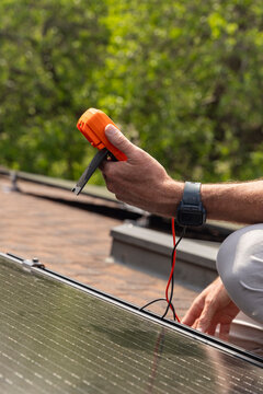 House Solar Panel test voltmeter hand