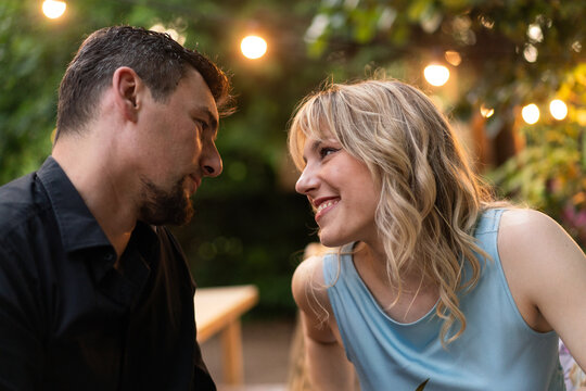 Romantic Couple Enjoying Evening Outdoors with String Lights