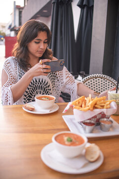 Latin woman taking picture