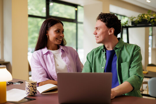 Coworkers Smiling During Workspace Chat