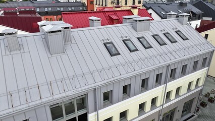 A residential building with offices featuring dormer windows on the roof. Contemporary European...