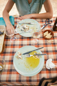 Sitting at table in front of dirty and empty dishes