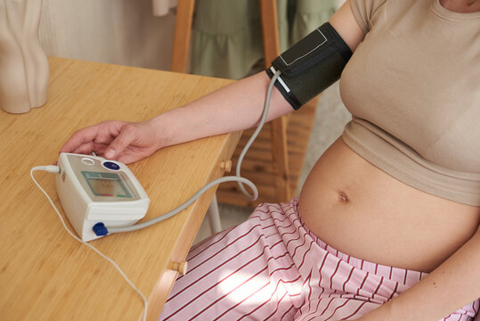 Monitoring blood pressure while sitting at a wooden table