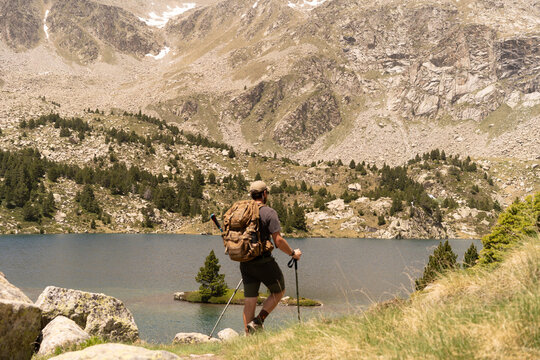 Hiker overlooking alpine lake