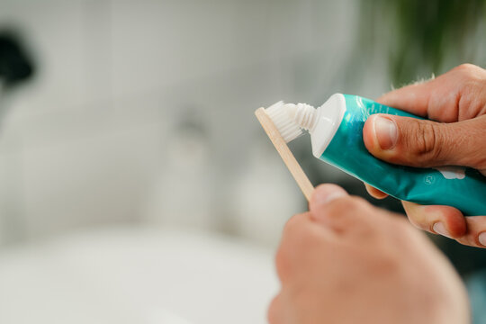 Man's hands with toothpaste and brush
