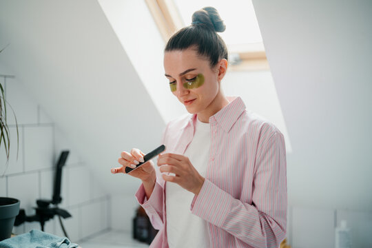 A woman gets a manicure for herself