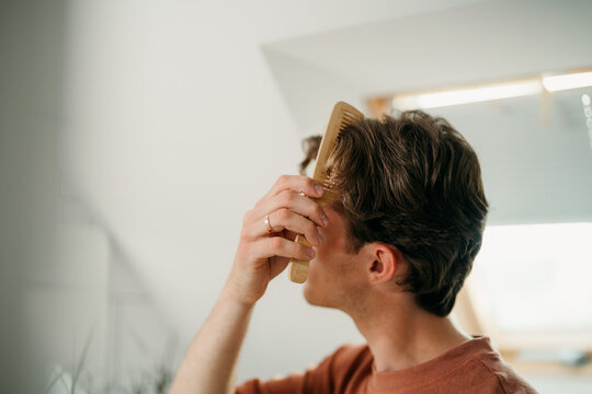 A man combs his hair