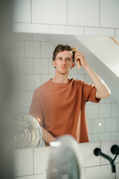 A man combs his hair