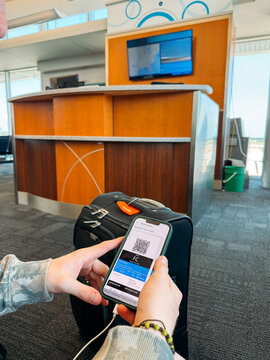 Checking Boarding Pass on Phone in Airport UGC
