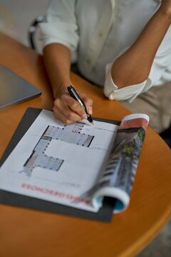 Professional Working on Architectural Plans at a Desk