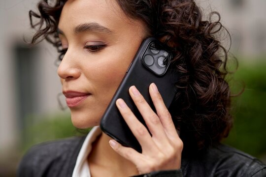 Young Woman Talking on the Phone Outdoors in Urban Setting
