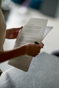 Person holding documents while reviewing important information