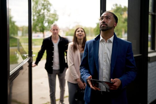 Real Estate Agent Shows Potential Buyers a Property