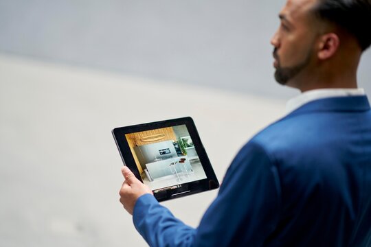 Person Using a Tablet to View Interior Design at  a construction site